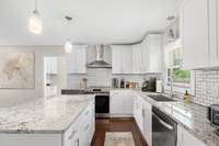 Beautiful and Spacious kitchen with granite top, undermount sink, tile backsplash and stainless appliances.  Beautiful and functional