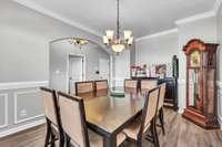 Elegant Formal Dining Room Featuring Beautiful Crown Molding and Wainscoting.