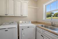 Laundry room with storage and sink