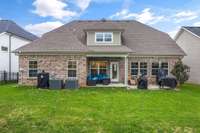 Covered patio and extended concrete for grilling and entertaining.