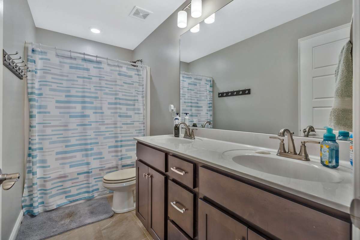 Full bath with double sinks and linen closet for extra storage. Room for plenty of towel hooks.