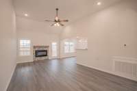 Large Living Room with a Stone Fireplace, Floating Wood Mantle, Crown Molding and Access to the Large Covered Deck!