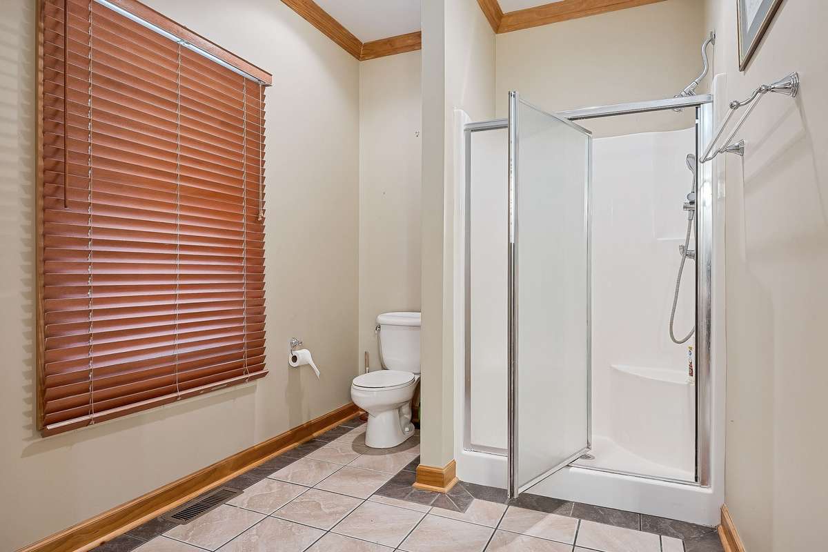 The primary bedroom has tile floors and a walk-in shower.