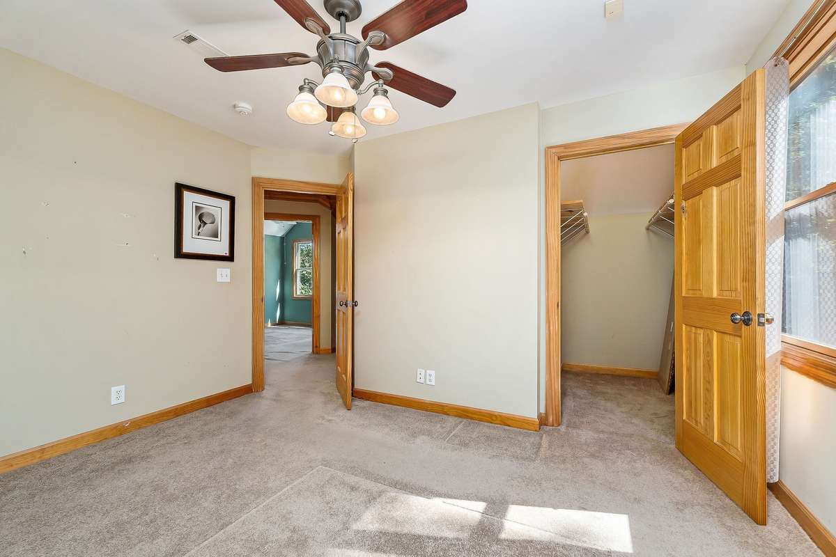 The second bedroom also features a large closet and a ceiling fan.