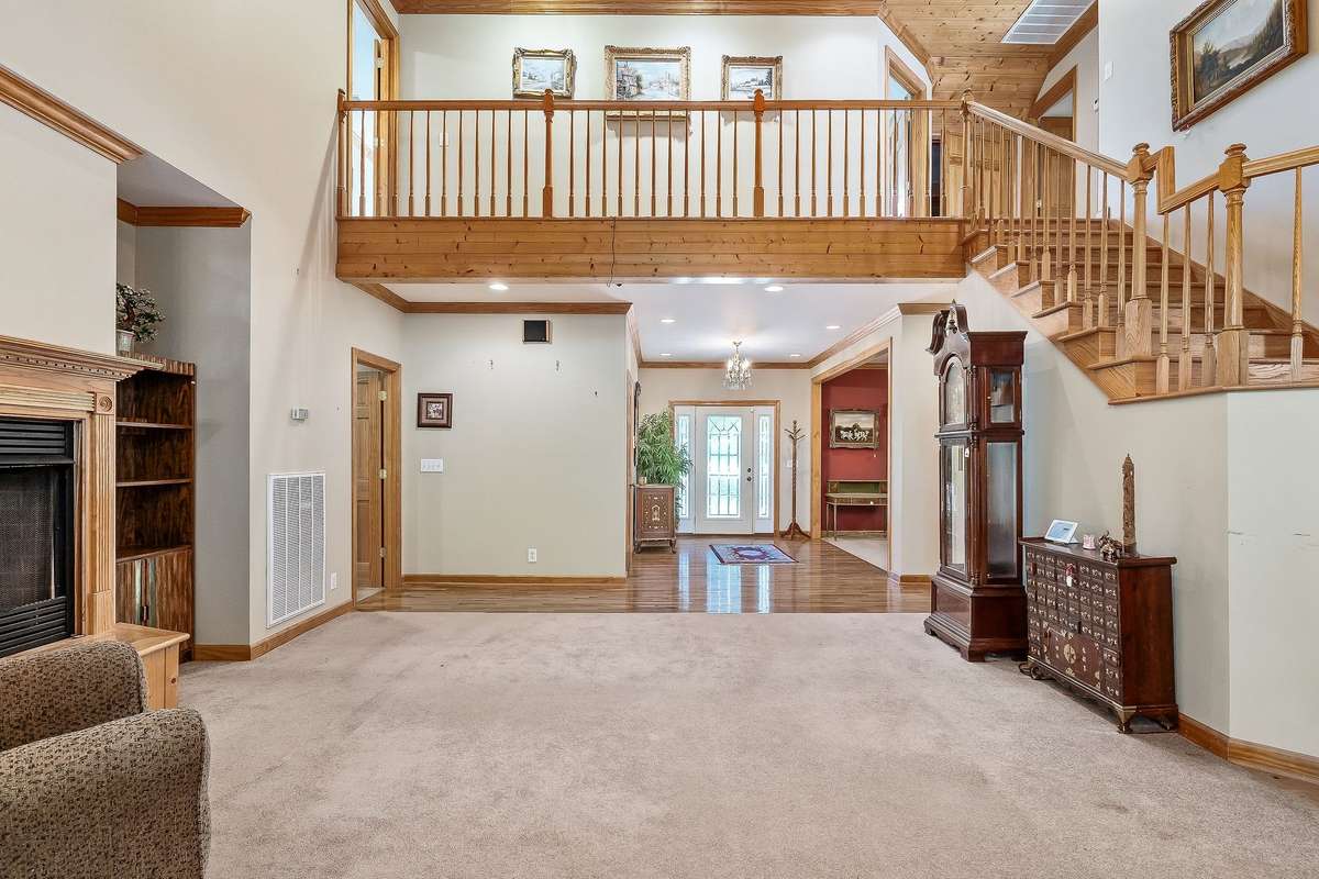 This home is perfect for a large family. The view from the living room leads to the front door.  This is such an inviting room.