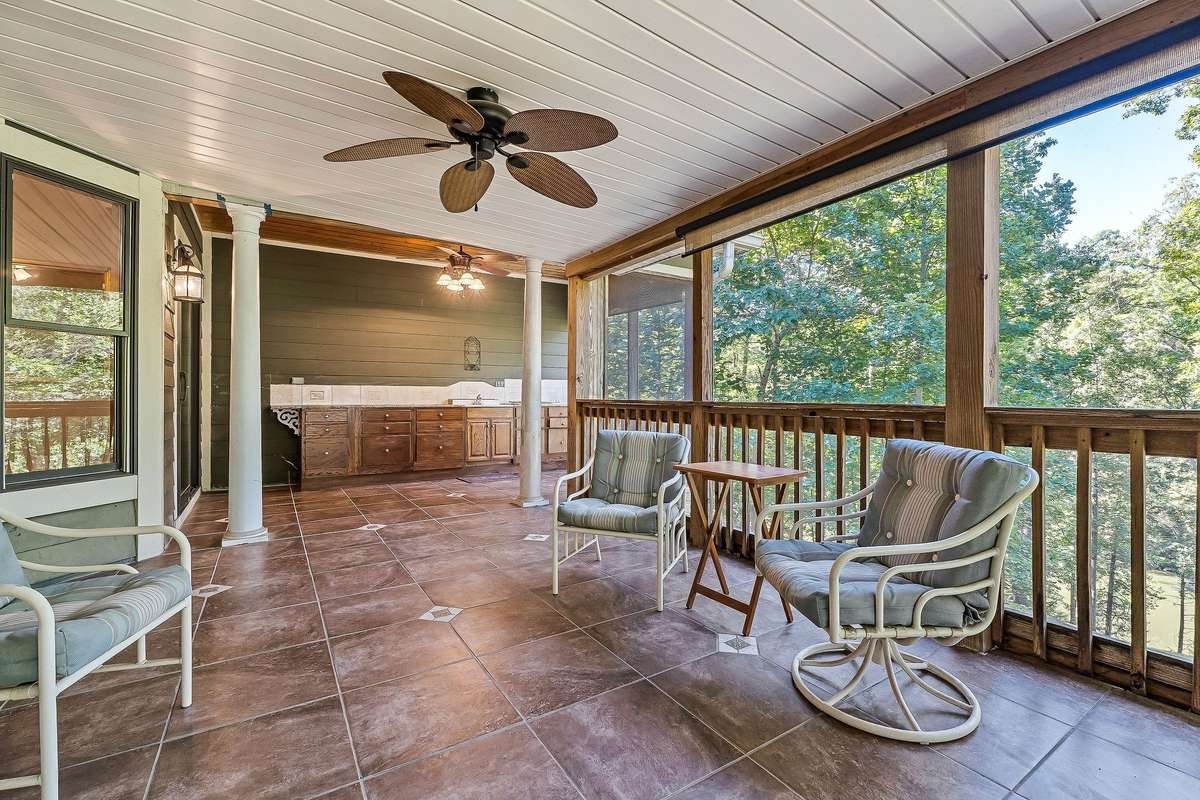 The outdoor kitchen with a cooktop is another feature of the screened-in porch.  There are shades you can use when needed.