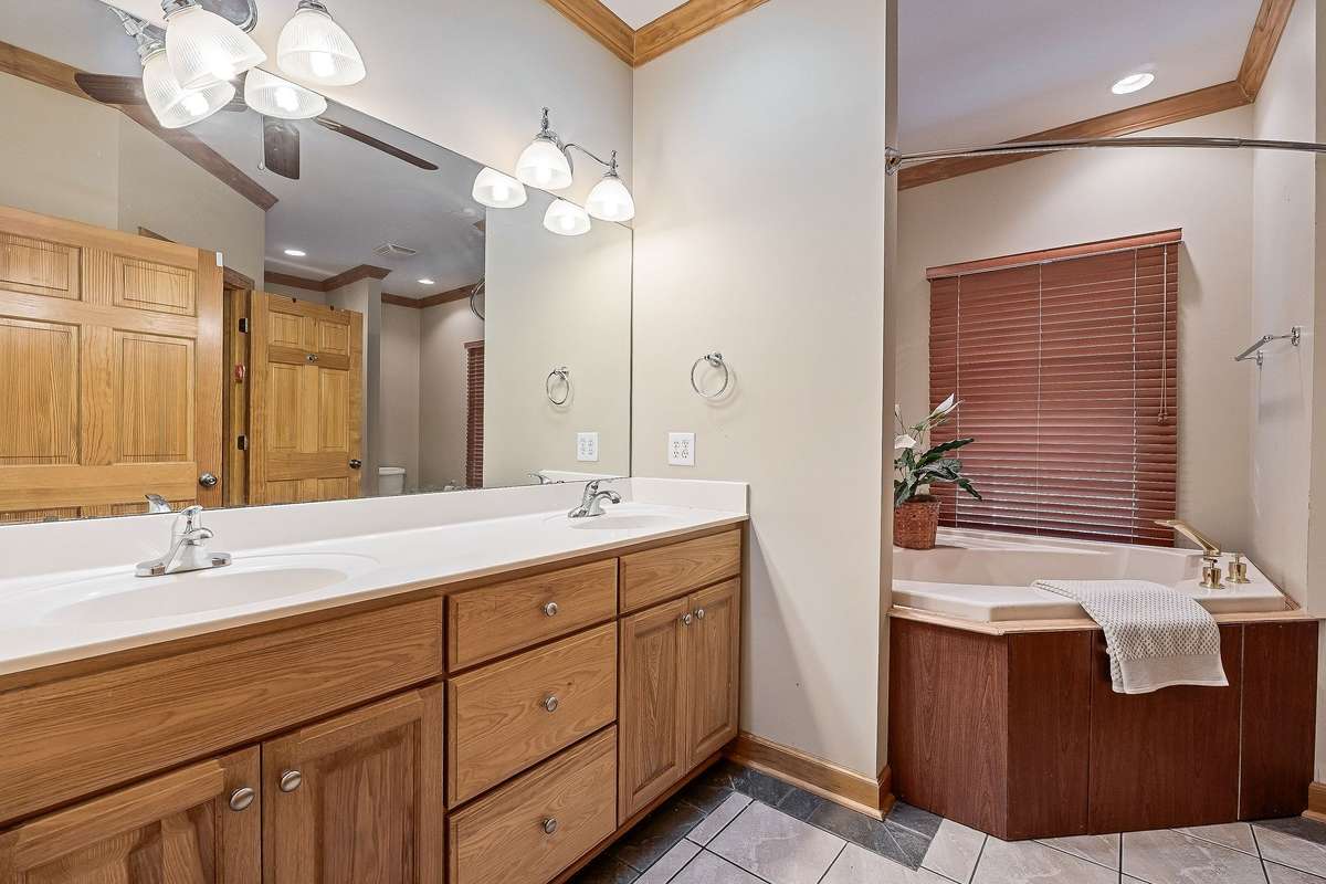 The primary bathroom features dual sinks, a jacuzzi tub and a separate shower.