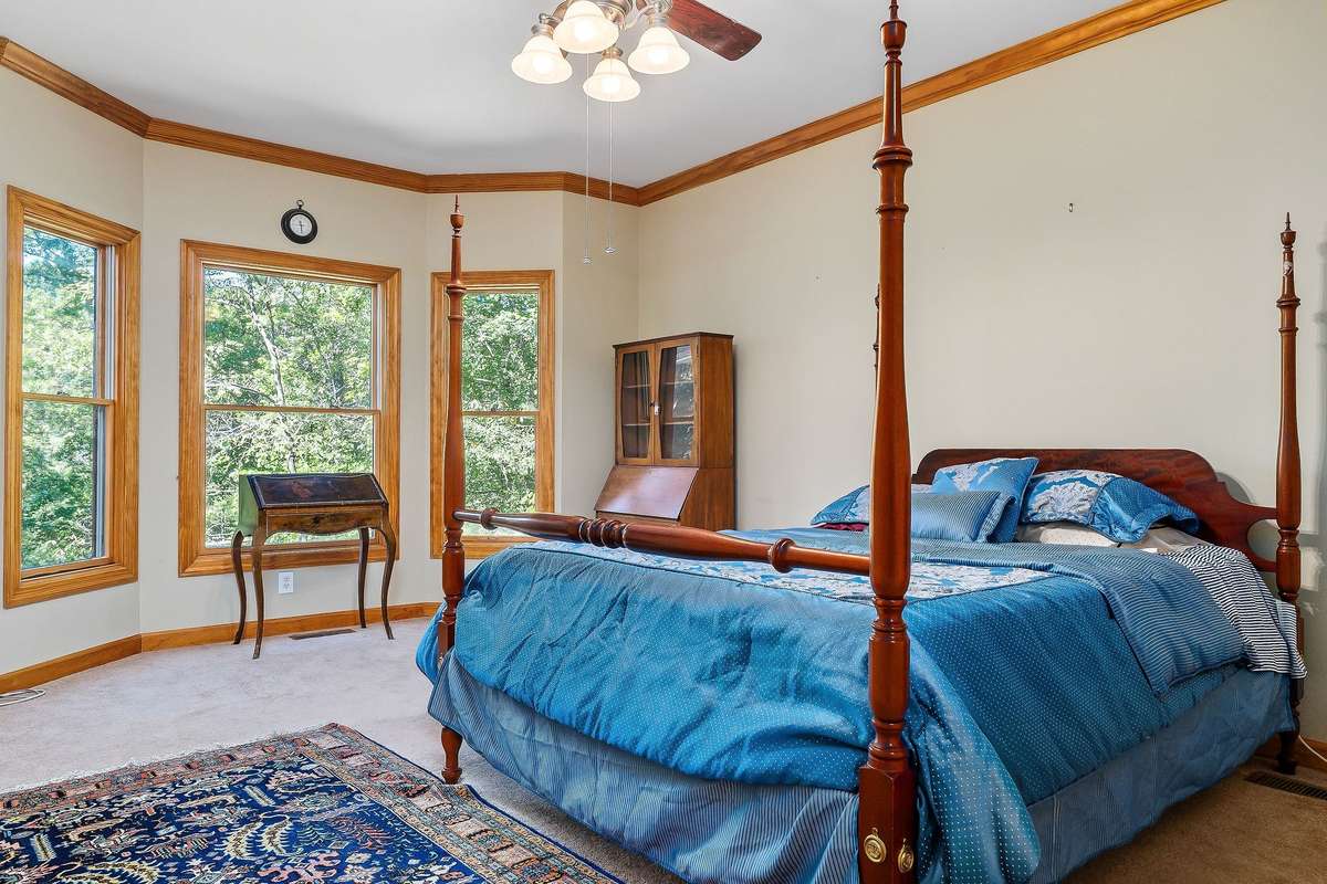 The primary bedroom is on the main level and has a bay window, which you can use to create a sitting area and enjoy the gorgeous view of the Rocky River.