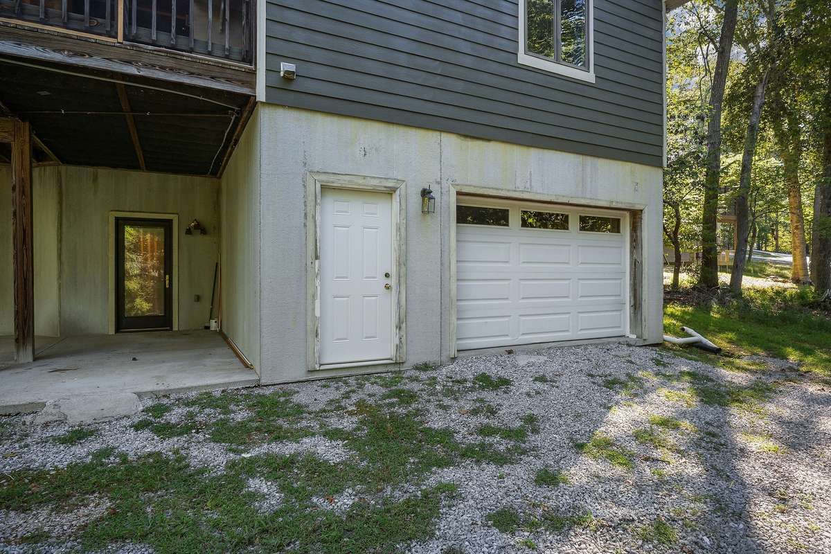 The driveway leads around the back of the home to the backyard and attached garage. There is also a garage door for entrance into the home.
