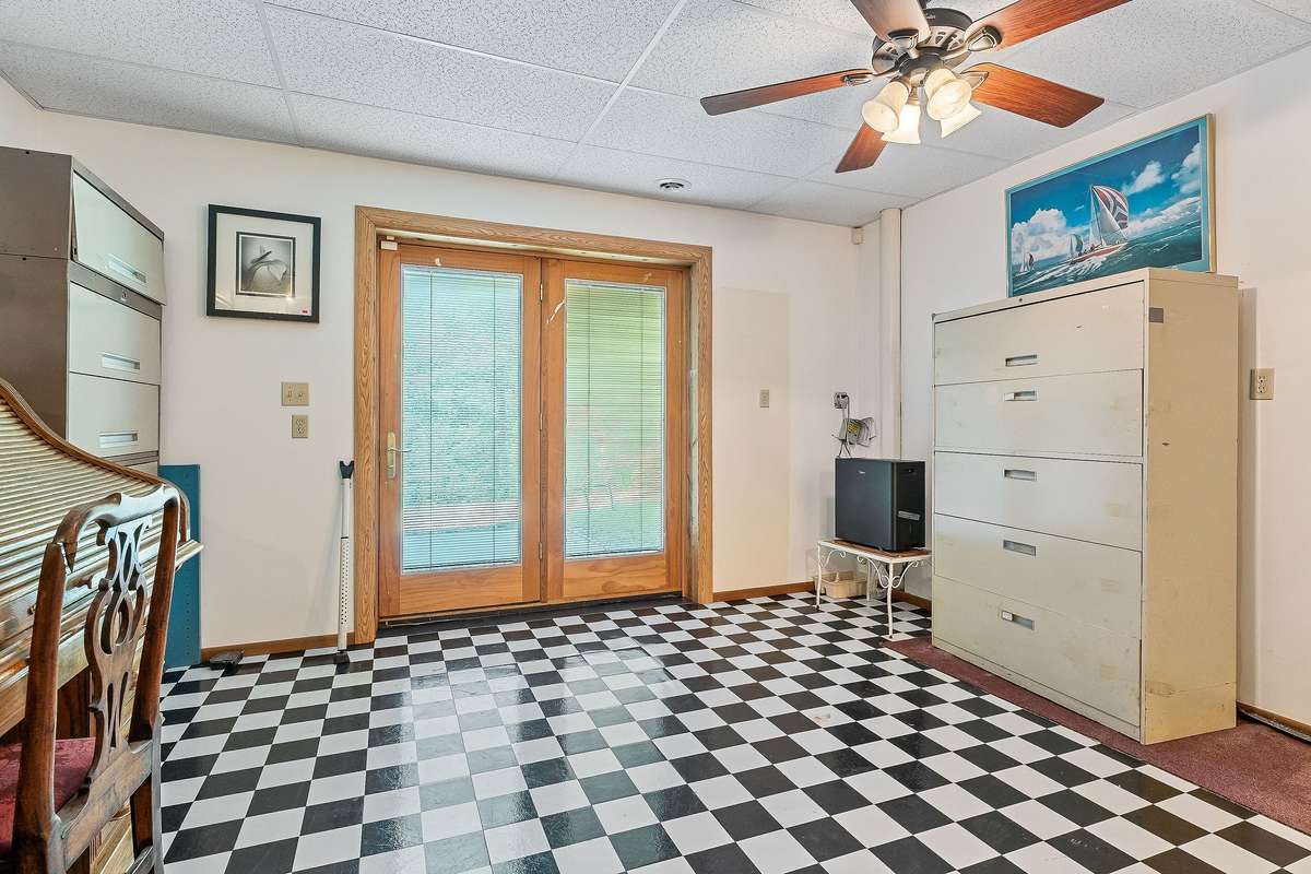 This room is set up as an office.  It has access to the patio and the backyard which leads to the river.