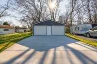 Concrete driveway leading to 29 x 23 garage with heat & air and 2 garage door openers