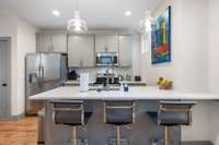 Second floor kitchen with quartz countertops and bar seating