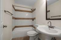 Note the beautiful tiled surround tub/shower combo!