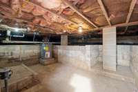 Crawl space is awesome for storage or small workshop!   Water heater is located here! There is a working sump pump -so no worries about flooding!