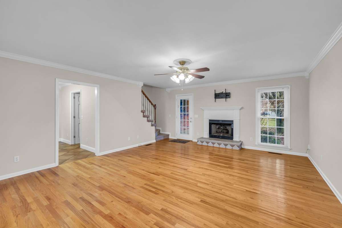 Great Room with hardwood flooring, gas logs in fireplace and opens to the covered deck in back!