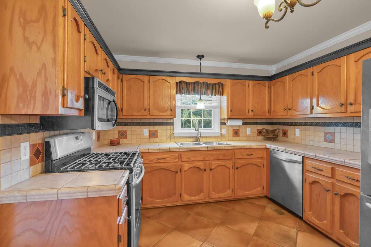 Plenty of cabinet storage, Built-in pantry, Stainless appliances includes a gas stove (and electric hook up) .