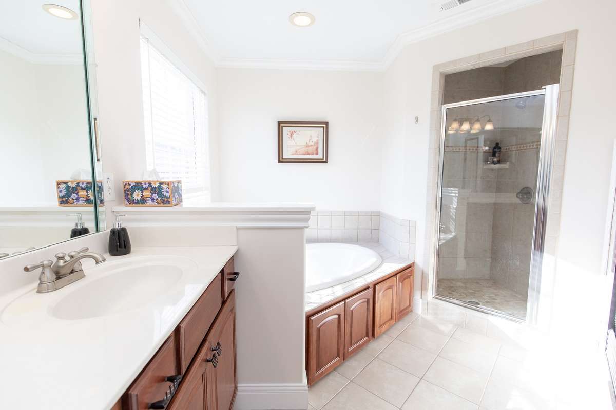 This spa like bath offers a walk in shower, jetted tub, his & her sinks with a makeup vanity area
