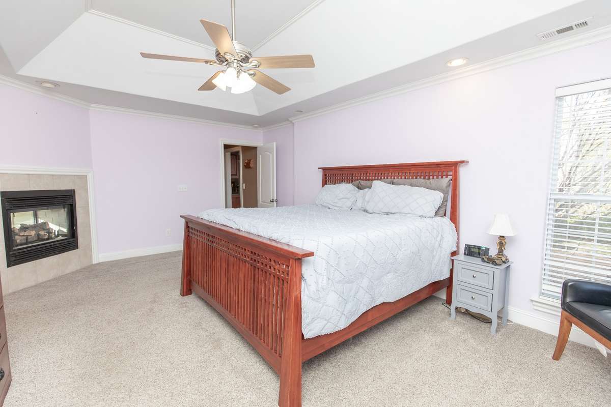 The primary suite is to die for!!  It offers a trey ceiling, double sided fireplace that shares with the bathroom, walk in closet, recessed lights and a ceiling fan