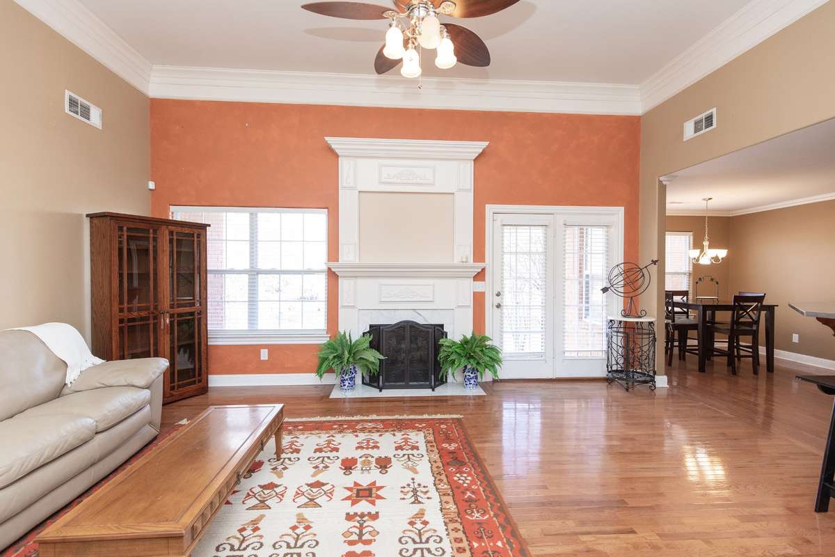 The family room boasts 12' smooth ceilings, gleaming hardwoods, gas fireplace, open to the kitchen with lots of natural light
