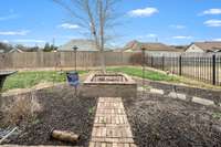 A brick walkway leads you out to the custom firepit.
