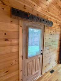 Hand hewn log transom over front door.