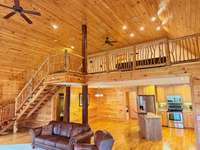 Custom cedar stair case, bannister and spindles leading to second level of home.