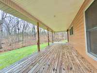 Spacious covered front porch for watching the wildlife walk by.