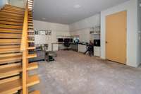This living space on the lower level of the home is currently used as an office with extensive built in storage and workspace.