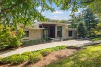 Welcome to Zen Hollow - an architecturally significant residence set on 5.37 acres of conservation-protected land within Natchez Bend Estates, offering privacy and a natural setting.