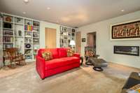 Adjacent to the office, this living space is a comfortable place to relax by the fireplace.