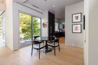 Breakfast area adjacent to the kitchen with balcony access, ideal for casual dining amid the surrounding landscape.