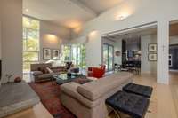 Great room with soaring ceilings, expansive floor-to-ceiling windows, and seamless connection to outdoor living areas. Automated Savant & Lutron systems manage lighting, climate & shades.