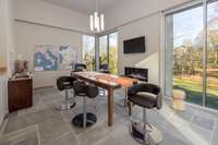 Dedicated wine tasting room with fireplace, floor-to-ceiling windows, and views of the surrounding landscape.