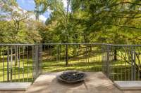 Lower terrace fire feature positioned to view the rolling, wooded landscape.