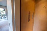 Residential elevator providing seamless access between levels, integrated discreetly into the home’s architectural design.