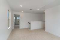 Upstairs, find a thoughtful loft for additional living space + three large bedrooms, two full baths & laundry room.