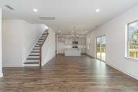 The large great room seamlessly connects to the dining area + spacious kitchen with large island.