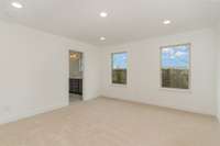 The primary suite boasts additional closet space + a sizable spa-like bath.