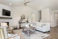 Enjoy cozy evenings in the comfortable living room, complete with vaulted ceilings + an abundance of natural light.