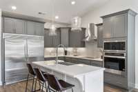 The large island frames our gourmet kitchen beautifully with generous cabinet space + walk-in pantry!