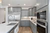 The large island frames our gourmet kitchen beautifully with generous cabinet space + walk-in pantry!