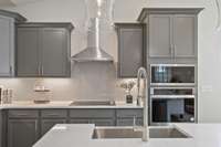 The large island frames our gourmet kitchen beautifully with generous cabinet space + walk-in pantry!