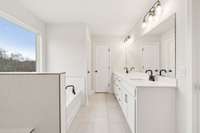 Double sinks set in quartz countertops and durable, stylish tile flooring are also included in the Owner's Bathroom.