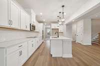 Designed for both style and function, this gourmet kitchen features a gas cooktop, double ovens, and black accents adding a modern, sophisticated touch. Perfect for home chefs and entertainers alike!