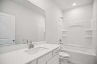 Bath #2 features durable tile flooring and quartz countertops for a modern, functional design.