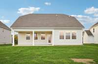 This photo highlights the rear of the home, showcasing the generously sized covered patio for outdoor living and entertaining.