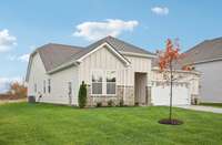 Stone details and Hardie siding work together seamlessly to boost the curb appeal of this charming 2,097-square-foot single-level home.