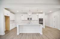 Convenient bar-stool seating at the island provides the perfect spot for casual meals or gathering with friends.