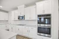 We have included stainless steel appliances including a dishwasher, microwave, electric cooktop and built-in double ovens!