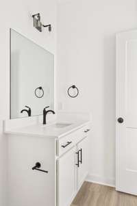 Modern white cabinetry with black fixtures to accent! Photo of similar home.